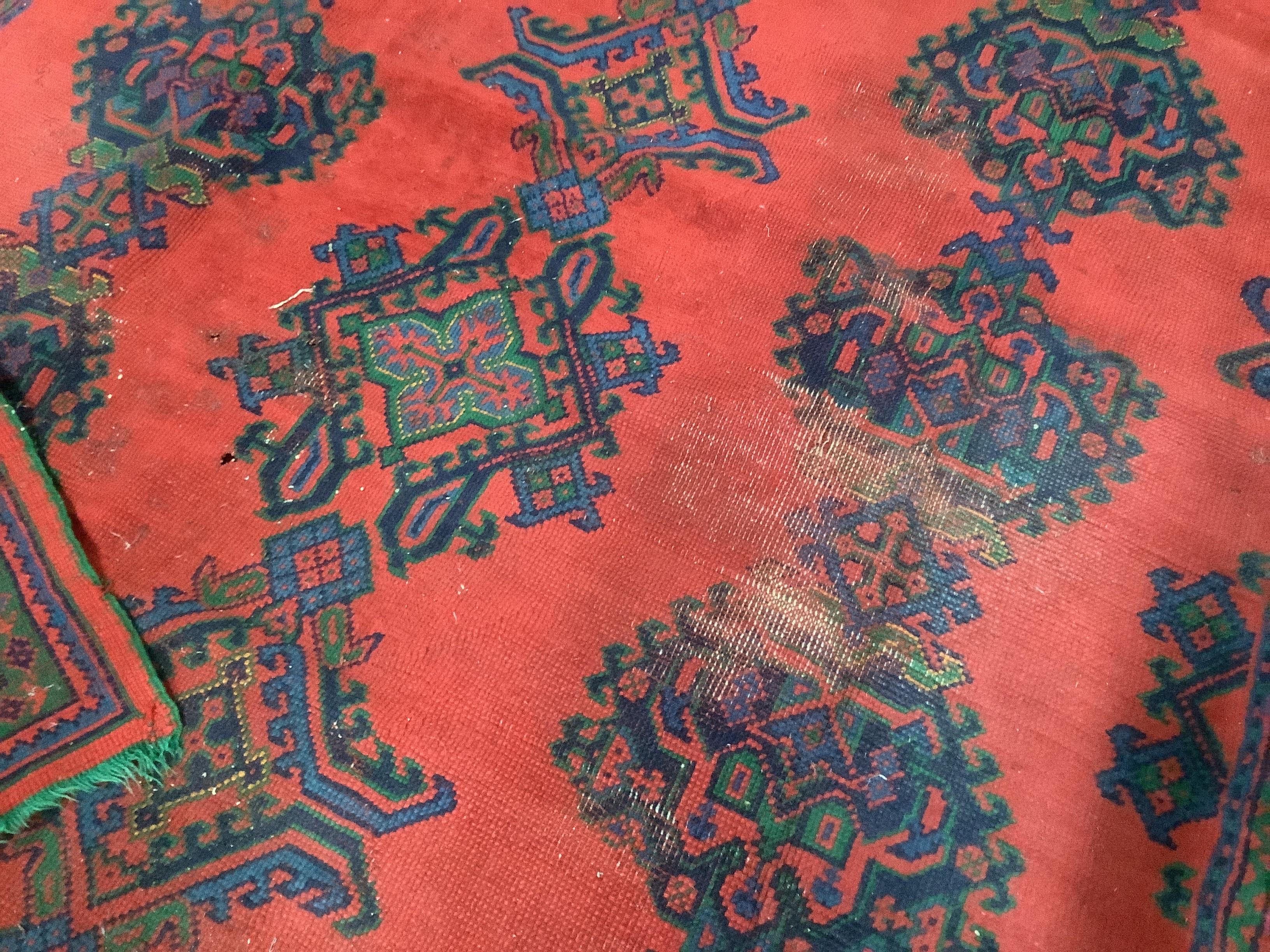 A Turkish red ground carpet, 350 x 278cm